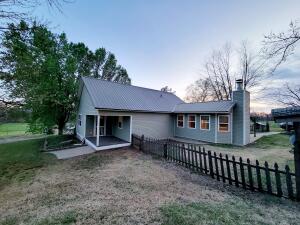 Cozy 2-Bedroom, 1-Bath Home on 4.4 Acres with Breathtaking Mountain Views. Seller offering a $10,000 allowance for heat and air with an acceptable offer. Nestled on 4.4 acres, this charming 2-bedroom, 1-bath home offers the perfect blend of country living with city conveniences. Enjoy stunning mountain views while benefiting from city water and sewer services. Inside, a wood-burning fireplace creates a cozy atmosphere, while the spacious kitchen and dining room provide plenty of room for gatherings. The large bathroom adds extra comfort. Step outside to a picturesque picket-fenced backyard, perfect for children to play safely. A pad is already in place for a shop or an additional home, offering endless possibilities. Don't miss this peaceful retreat with room to grow!