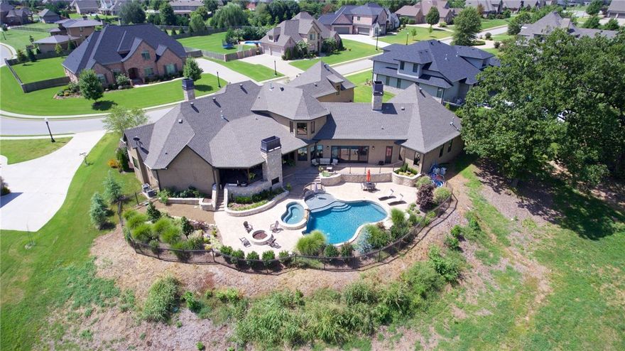 Make this resort style paradise your permanent home! Mark Melton Construction: builder's personal home packed with quality. Stunningly gorgeous, entertainer's delight! The massive gourmet kitchen, room size pantry and wine room is open to the family room with unbelievable views of the pool, attached hot tub, covered patio, cozy outdoor fireplace, and built in grill. Spacious master suite has a unique master bath and huge closet with laundry hookups. Upstairs getaway areas include a game room and media.