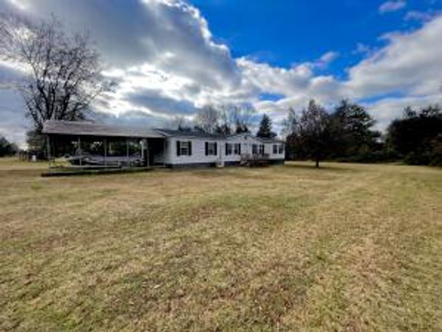 3 bed 2 bath split floor plan mobile home with 1.8 acres.The home offers plenty of space for entertaining. Has an additional family room with wood fireplace. Sit on your back porch and enjoy the county setting. There is a large detached metal carport.