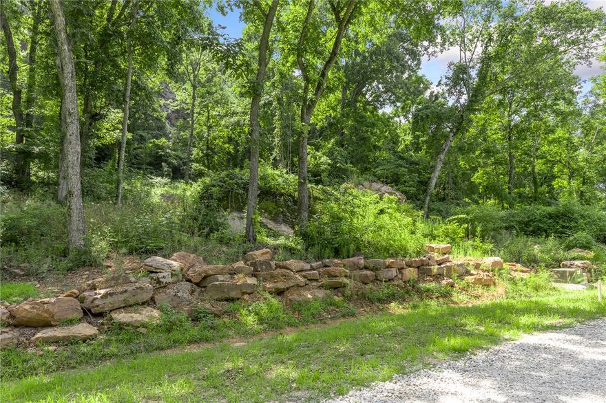 The groundwork is already done for you!  This lot comes fully equipped with underground utilities already in place, including natural gas, fiber optic internet, electric, public water, and sewer. No waiting, no guesswork, no costly setup—just a smooth, ready-to-build opportunity from day one. Welcome to Lot 116 (1.10 m/l ac) at Round Mountain Estates. A very tree shaded lot with unique boulders and Round Mountain bluff line lying to the east. This lot also offers ownership across Significance Summit so you can clear your own property to create as big of a view as your heart desires! RME is the newest subdivision in Harrison, AR. If you’ve been dreaming of trading city lights for star-filled skies, RME delivers. Beyond your homesite, you’ll have access to a 350 acre common area reserved for residents, featuring a stocked fishing pond, Kissing Rock Trail, natural springs, Baby Canyon Trail, striking bluff lines and views that stretch for miles.  *Terrapin Creek Rd will be paved in the future, per county officials.