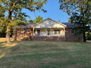 We've got the perfect place to make your mini farm dreams come true! This 4 bedroom, 3 bathroom home sits on 4 private, wooded acres, 1 of which is fenced in for horses, goats, or chickens. The property features a spacious master suite with his & hers closets, double sinks, and a jacuzzi tub/ shower combo. Two of the bedrooms have a Jack & Jill style bathroom. The home has a wood-burning stove in addition to the central heat and air system. You are sure to enjoy the covered porch with outdoor fans. There is a 2 car carport attached to the shop with electricity & another car carport attached to the house.This home is located just minutes from Big Piney and the bayou, perfect for those who love to spend their weekends on the water! Can be purchased with 8 or 12 acres for additional pric