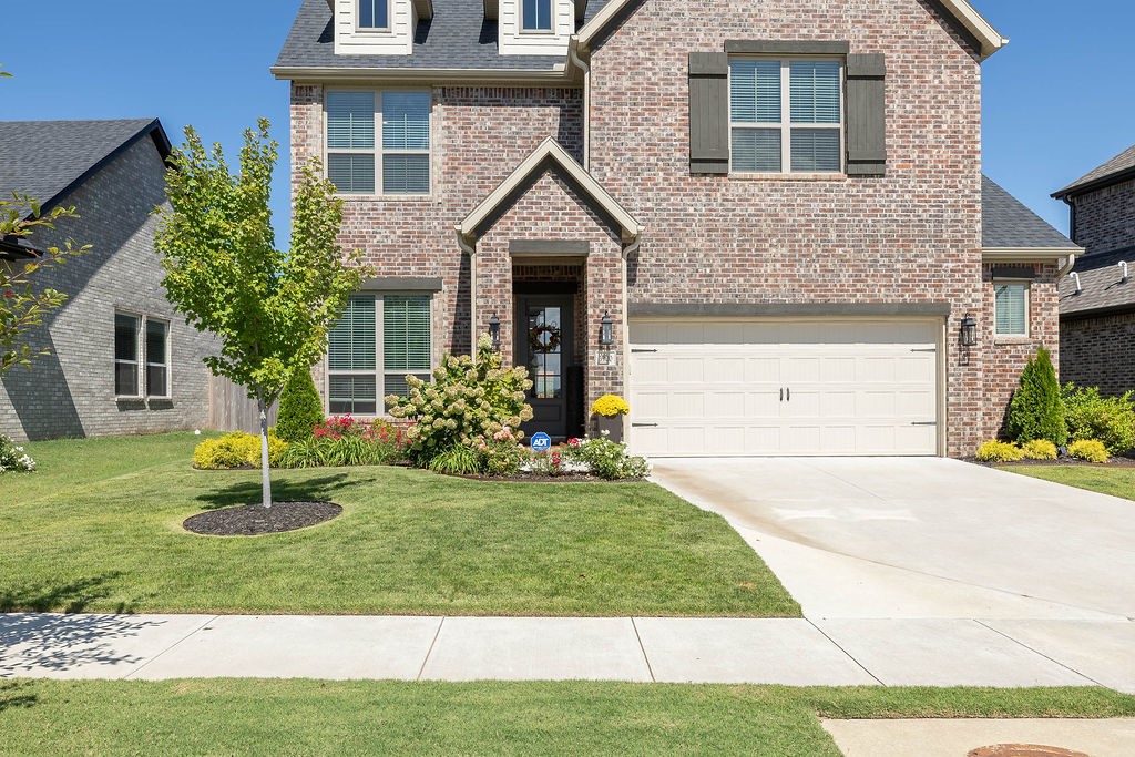 Located in the highly desirable Magnolia Park subdivision, this lovely 3-bed/2.5 bath home combines comfort, style, and convenience. Open concept living makes entertaining a breeze! Lovely kitchen with cabinets all the way to ceiling and a large covered back porch with a gas fireplace for cool evenings. Built-in entertainment bar has ice maker and beverage fridge. Upstairs bath has two sinks and tons of space. Beautiful landscaping. Garage has electric charger for electric vehicles. Walk-in storage. Only one owner, you have to see this beautiful, almost-new construction with proximity to I-49, the U of A, and the highly anticipated Mt. Comfort Square.