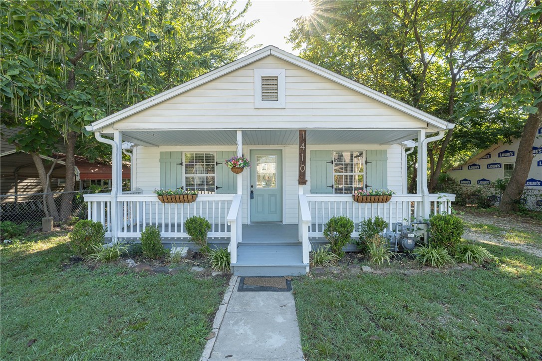 Charming move-in-ready 3 bedroom, 2 bath cottage style home in south Fayetteville. Features include new LVP flooring throughout the home, fresh interior paint, updated main bathroom with gorgeous new tile. Enjoy spacious walk-in closets, updated light fixtures in living and dining room, and a newer roof for peace of mind. Relax on the covered front porch or move back to the wood deck on the back for privacy both sanded and repainted, gutter guards. Home recently had an energy audit with additional insulation and new sealing of windows and doors. Nice backyard for cookouts. Close to the University and the Fayetteville Square. The outbuilding is probably a tear down. Selling "as is".