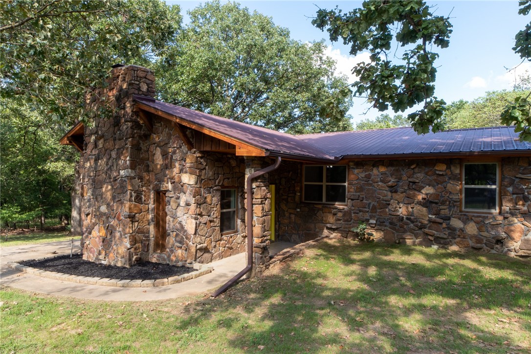 Beautiful stone and cedar home with unique floor plan, fully remodeled and fun, sitting on 1.38 Acres! Features in the 2,482 SF include 4 levels (no more than 5 steps to each level), 5BR/3BA and a 20-foot native stone fireplace in the supersized family room. Private master balcony is spacious, and the lower-level patio is covered with ample room for a hot tub. Large yard and a detached garage with a shop area. Additional storage unit not even 5 minutes to Prairie Grove town. Completely remodeled with new windows, flooring, paint, baths and more!