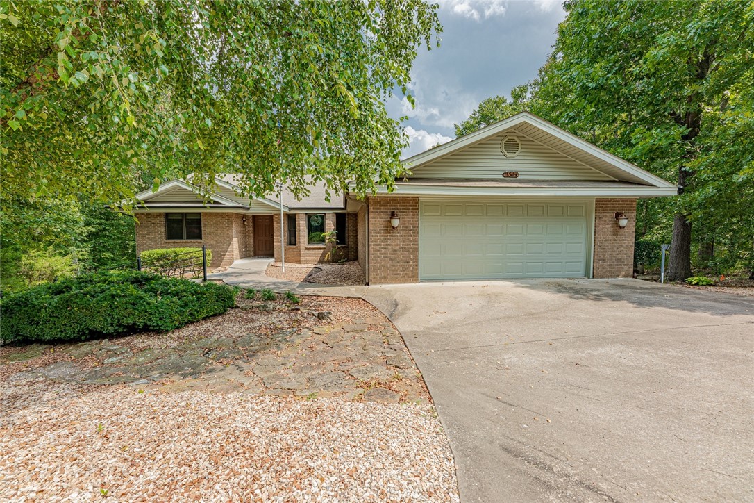 One level home offering 1,836 sf, 3 bedrooms, 2 bathrooms, 25x24 garage & level driveway & walkway to covered front entry, nicely appointed kitchen with deck access, pantry cabinet, message center and more. Formal dining area with bay window & large living room with gas log fireplace & 2 solar tubes. Split bedroom plan for guest privacy. Large laundry with built-in ironing board, sink & cabinets. The oversized garage has storage cabinets & attic storage. 18x10 sunroom has no HVAC (not in sf). There are 2 large rooms in the basement with outside entrance (not in sf) with tall ceilings, shelving, etc and would make great workshop, exercise room, storage, or man cave & she cave. Yard is nicely landscaped with many new plantings and a wooded view out the back. The vacant lot to the right of the home conveys. Water heater about 5 years old and HVAC is 2010. Complete appliance package includes washer, dryer & refrigerator. Located close to Loch Lomond walking trail, dog park & Branchwood rec center & 2 golf courses.