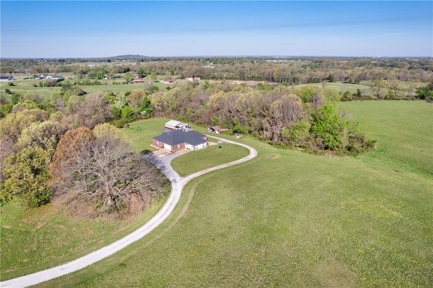 Enjoy space, privacy and functionality on 5.58 acres with this thoughtfully laid-out three-bedroom, 2-bath home. A versatile welcoming living/entertainment area provides the perfect space for movies, playtime or a retreat, flowing seamlessly into the main living room, dining area and kitchen for a functional layout that works well for both everyday life and entertaining. The primary bedroom offers a private sanctuary with its own bathroom, while two additional bedrooms are connected by a Jack-and-Jill bath, providing convenience and flexibility. Step outside to the back deck and enjoy views of the open land directly behind the home, an ideal location for a future pool or expanded outdoor oasis. An insulated shop with electricity enhances the property’s usability and offers endless possibilities. With acreage that invites expansion and a layout built for comfortable daily living, this property presents a rare opportunity to enjoy both space and practicality in a setting that’s becoming increasingly hard to find.