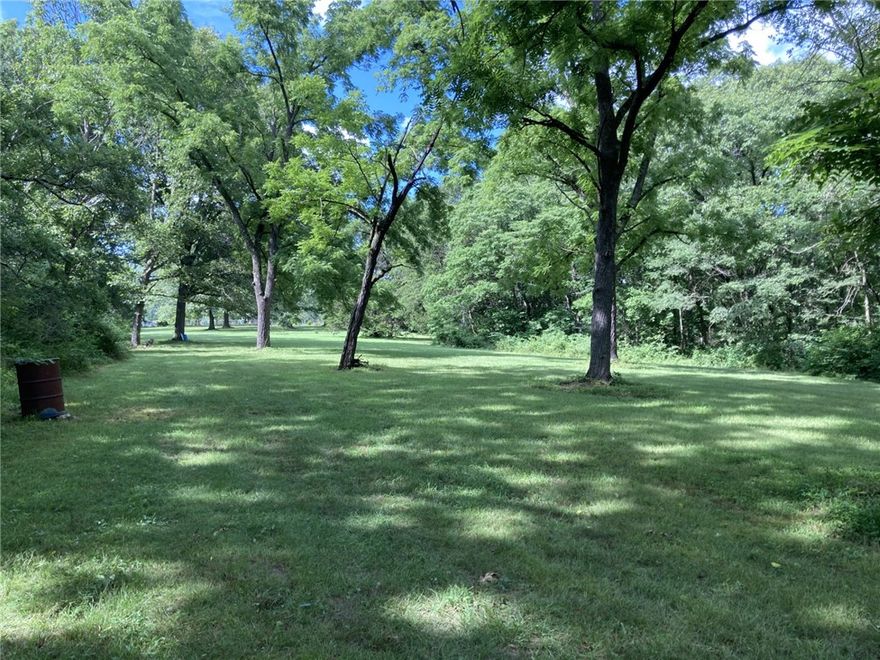Discover a rare opportunity to own just over 5 pristine acres with a coveted Bentonville address—located outside city limits for added freedom and privacy. This unique property offers the best of both worlds: approximately half is cleared, flat, and ready for your dream home, while the other half remains wooded, creating a natural buffer and peaceful seclusion. A gated entrance adds security and convenience. A perk test has been completed, and results will convey. Hard-to-find flat acreage in this prime location—close to world-class bike trails, top-rated schools, and all the amenities Northwest Arkansas has to offer—makes this a must-see for those seeking space, serenity, and convenience.