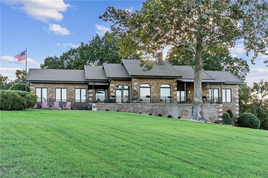 YEAR ROUND LAKE VIEW + BOAT SLIP in community dock! This custom-built, steel frame home offers breathtaking YEAR ROUND views of Beaver Lake from every room. Completely remodeled with new paint, cabinets, LVP flooring, Pella windows and French doors. Chef's kitchen includes all new appliances, 12' island with quartz countertops & light pendants that were hand painted in Morocco. The luxury primary bed & bath features new tile & wood accent walls, towel heaters, free standing soaking tub, & light up mirrors. Enjoy radiant heated floors throughout, new Pella windows, & the expansive patio is perfect for relaxing & taking in the scenery. The home also features geothermal HVAC, whole house generator, & a 100-year concrete shingle roof. Plus, the home comes with a fully enclosed boat slip with a rolling garage door in a community slip just a 3-minute golf cart ride away. This home offers superior quality, energy efficiency, & the ultimate lakefront lifestyle. Ask about our preferred lender credit!