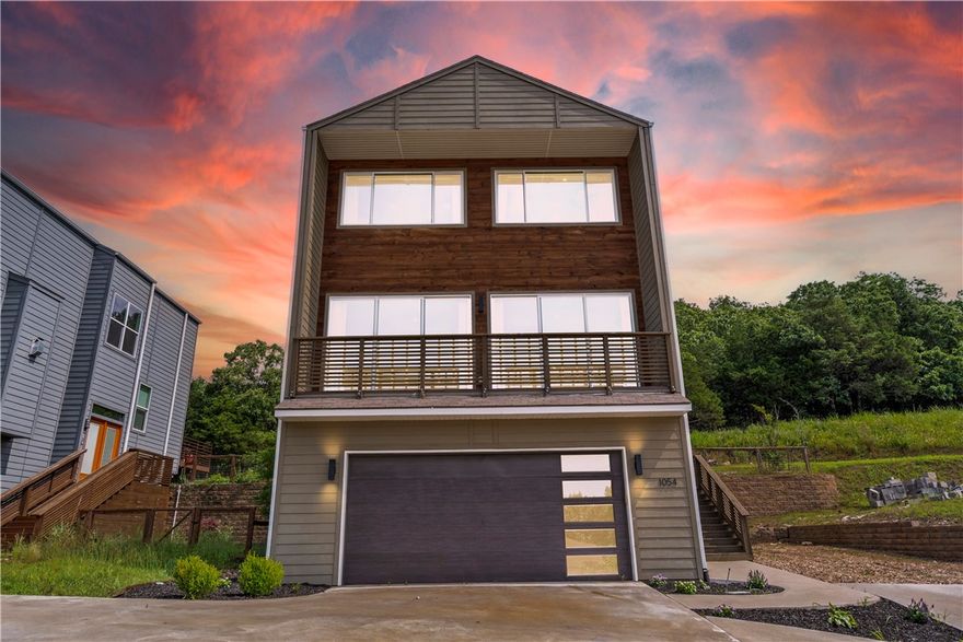 Welcome to this stunning three-level modern home nestled in the heart of Fayetteville, just minutes from the University of Arkansas campus! This spacious 4-bedroom, 3.5-bath residence offers a perfect blend of style and functionality, featuring an open layout with expansive windows that showcase breathtaking mountainous views. Enjoy entertaining or relaxing on the large patio, or unwind in the bright bonus room flooded with natural light. The gourmet kitchen and bathrooms are adorned with beautiful granite countertops throughout, while the luxurious primary suite boasts a custom-designed shower. Ample storage is available on every level, making organization a breeze. With its prime location, contemporary finishes, and thoughtful design, this home is ideal for families, professionals, or Razorback fans seeking comfort and convenience. Don’t miss your chance to own this exceptional property in one of Fayetteville’s most desirable areas! Schedule your private tour today!