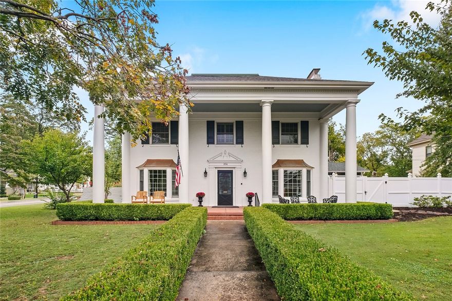 Nestled in the heart of Historic Fayetteville, this luxurious residence exudes elegance and charm. Meticulously restored and sitting at 3,927 sf, this home is poised on the iconic, sprawling corner of Washington and Lafayette streets that welcomes you into Fayetteville's Historic District. Offering the perfect blend of classic architectural beauty with modern convenience, this stately, historic home features 4 bedrooms, 6 bathrooms (4 full, 2 half) and spans three levels. The gourmet kitchen is a chef's dream, with high-end appliances, custom cabinetry, and an oversized center island that serves as the heart of the home. The home features four original fireplaces, all with functional gas logs, abundant natural light, and original white oak hardwood flooring throughout each story of the house. Location is paramount, and this home is perfectly located just 2 blocks from Dickson Street, 1 block from Ozark Natural Foods, and a pleasant 10-minute walk to the Fayetteville Downtown Square.