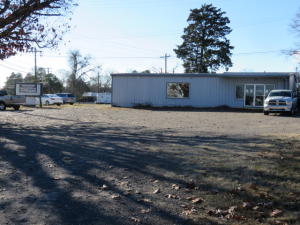 Excellent commercial building and acreage on the busy Highway 64/MAIN STREET! Owner built an attached new shop with 9000 lb hydraulic lift. Can't miss this optimal location! Real estate only. Extensively remodeled 4 years ago! Call for details! Buyer to verify the exact zoning for his/her future business.
