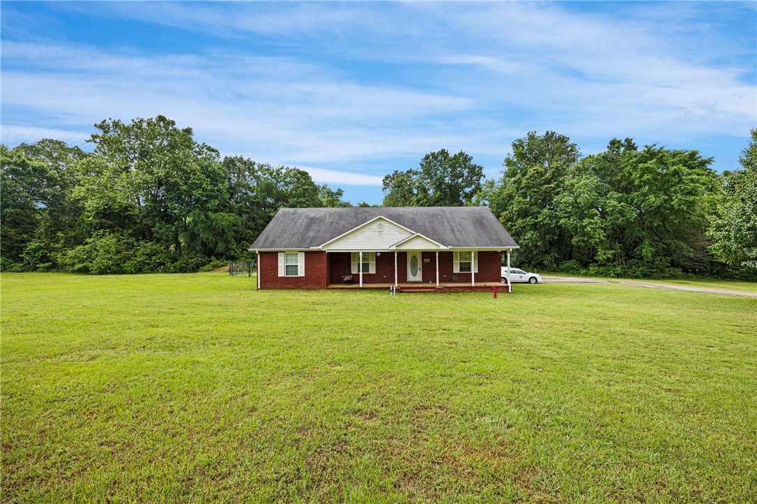 Beautiful country home on 4.4 acres located just minutes from town. This home features a spacious open floor plan that makes for comfortable living. Oversized laundry room with space for exercise equipment/hobby area or simply more storage. And don't forget the like new inground swimming pool with covered back porch and large patio area. Perfect for entertaining or just relaxing at the end of the day. Additional metal building is perfect for a shop area, tools, ATV, mowers etc. Don't miss seeing this one!