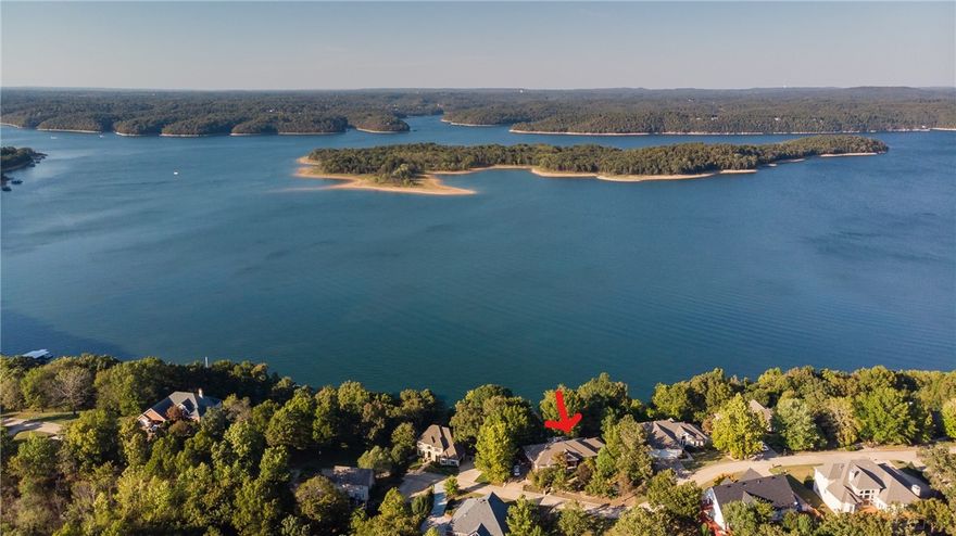 Looking for a LAKEFRONT, EXPANSIVE LAKEVIEW, PRIVATE BOAT DOCK home close to downtown Rogers? This is your opportunity!! Located in exclusive Serenity Point Subdivision, this home is minutes from shopping, dining, Hobbs St. park, trails, launch ramps, you name it. Custom built and constant care, maintenance and facelifts. Paved path to take a Gator down to your private dock with single 10x26 slip to include lift, extra wide swim deck partially covered. 4646 sq.ft., 2 levels, 3 beds, 3 baths, 2 living areas, formal dining, office, 2 bonus rooms, one is used as sewing room now, but could be another bed or workout room. 2nd bonus is currently a bedroom with an in-house storm shelter area. 2 sunrooms, one enclosed and temperature controlled.  Lots of windows to enjoy the expansive views of Bear & Deer Island and the main channel.  Kitchen cabinets are all pull out drawers on lower level.  8 ft. island with veggie sink and disposal with indirect lighting above. Ask your realtor for the list of features and COME SEE.