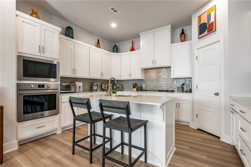 Built in 2023, this exceptional home blends modern design with comfortable, family-focused living in Bentonville’s Aurora Subdivision. Perfectly positioned beside a tranquil common area with mature trees and benches, the setting offers a rare sense of privacy while providing the ideal backdrop for morning coffee, evening walks, and outdoor play.
Thoughtfully designed for both style and function, the rear-entry garage—conveniently accessed from the alley—enhances curb appeal and creates a charming, pedestrian-friendly streetscape that encourages a true neighborhood feel.  residents enjoy resort-inspired amenities including two swimming pools (one adults-only), a pickleball court, open-air clubhouse, scenic walking trails, a dog park, and picnic areas.  A standout value, the seller has prepaid the 2026 HOA dues and internet fees—an incredible added benefit that reduces upfront costs and allows you to settle in with confidence.