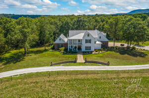 Farmhouse style with elegance describes this approx 4400 sq ft home on 21 1/2 acres with pretty view of the Ozark Mountains and located only 5 miles from Harrison. This custom built home is only 15 years old and in excellent condition! 3 or 4 bedrooms (bonus room could easily be the 4th bedroom) and 2 1/2 baths. 2x6 walls, 9 ft ceilings, big windows throughout, crown moulding, ash and hickory hardwood floors, gas fireplace in living room, wood stove in the beautiful glassed-in sun room. This dream eat-in kitchen has stainless steel appliances, Silestone quartz countertops, and a huge pantry. Formal dining room, den. Nice master suite on he main level with an office, his and her walk-in closets, newer master bath with heated tile floors, soaker tub, 2 vanities and a walk-in shower.