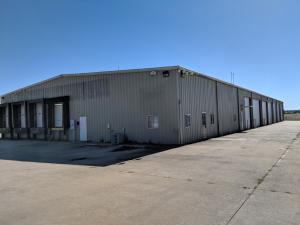 High traffic commercial location with large warehouse and office space. Concrete parking and fenced. 3.75 acres 15 ground level dock doors and 5 elevated docks. 1400 square ft of heated and cooled office space