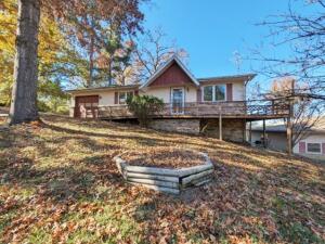 Enjoy living close to Bulls Shoals Lake and the White River with this 2 br 2 ba home on 1.08 acres m/l at the end of a dead end street in the very back of Leisure Hills S/D with 26' x 34' detached garage, attached 1 car garage, sunroom, wrap around deck, wood burning stove and so much more. All #s are approx, age is estimate, square footage & acreage per assessor, buyer to verify existence of septic.