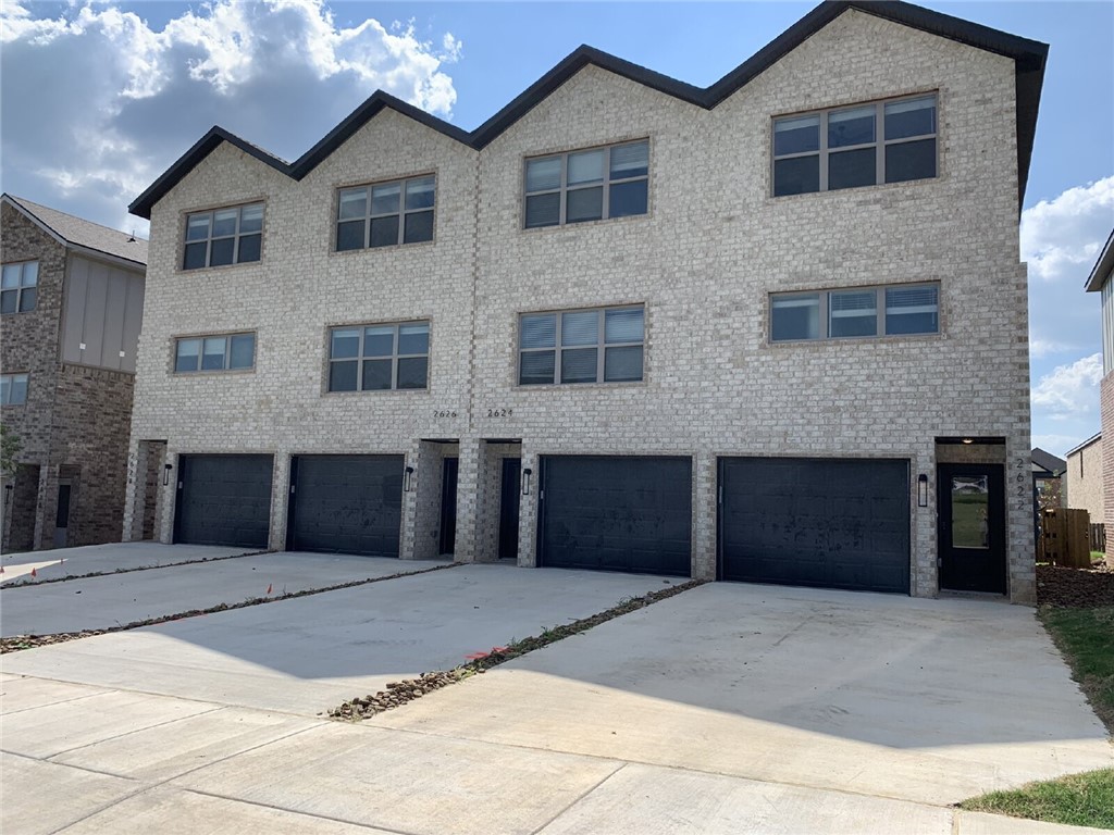 Amazing location directly across from Osage Park, Lake Bentonville, and the Bentonville Airport (private planes only—minimal noise). Enjoy quick access to Climb Bentonville, Bentonville Brewing, Walmart HQ (10 min), and the Downtown Square (15 min). The 2nd level boasts an open living room with abundant natural light, modern fixtures, and a sleek kitchen featuring white painted cabinets and quartz countertops. The primary suite offers a marbled walk-in shower and double vanity. Upstairs, find 2 guest bedrooms, full bath, office nook, and a spacious storage room. The main level includes a tandem 2-car garage, additional storage, and a fenced backyard with patio slab—perfect for relaxing or entertaining! **1 Year lease available at $2095 ($2070 deposit)**FIREPLACE DOES NOT WORK**$50 PET RENT PER PET**$350 NON-REFUNDABLE PER PET**