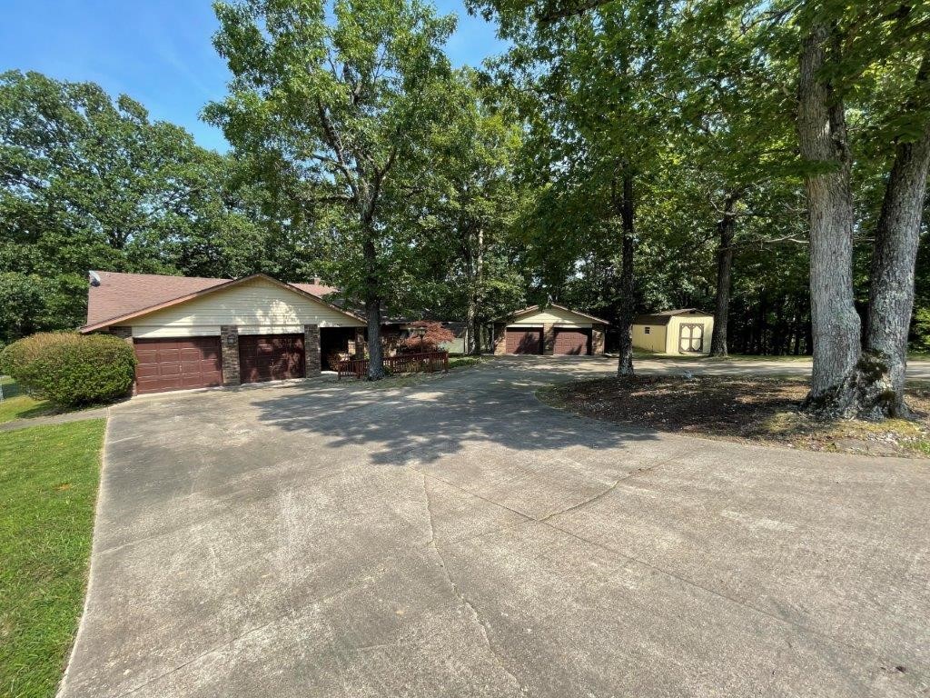 Well maintained home situated on 1.72 AC (+/-) with 3 bedrooms and 2 full bathrooms. Located just 3 minutes to Prairie Creek Marina and 9 minutes to Downtown Rogers! Large island in kitchen, woodstove in living area, heated and cooled sunroom with additional woodstove, walk-in closets, 2 car garage and an additional detached 2 car garage/workshop, and 2 storage sheds. Enjoy the peaceful large backyard with deck and hot tub overlooking wooded area. This home as so much to offer.