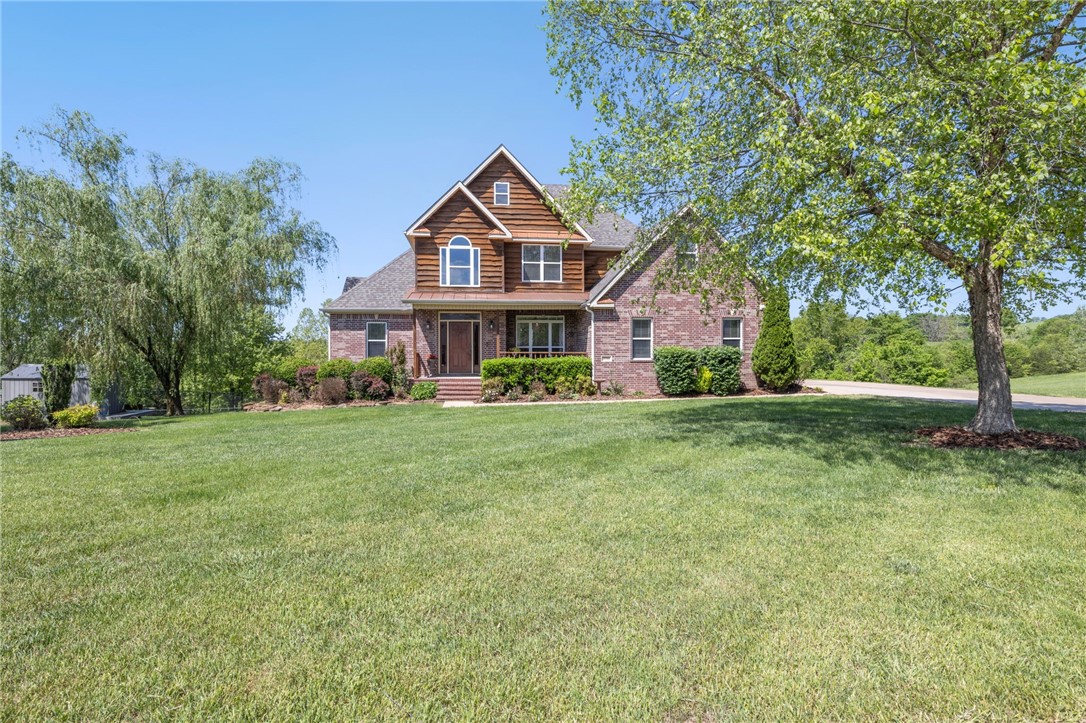 Lake Lovers! This beautiful home comes with the opportunity to also own, at an additional cost, one of the four boat slips in the private boat dock at the end of the street. Private lake access is approximately 200 yards. Love to fish? This is your neighborhood! Enjoy the primary bedroom on the main floor with three more bedrooms upstairs and another bedroom in the finished lower level. Main laundry room is on the main level. Install a stove in the lower level kitchen and you can enjoy a full apartment with a walk-out space. Additional Washer/Dryer Hookups also on this floor. Neighborhood is only 20 minutes to Tyson Foods, 35 minutes to Walmart Home Office, and 35 minutes to the University of Arkansas. Ask about the boat slip!