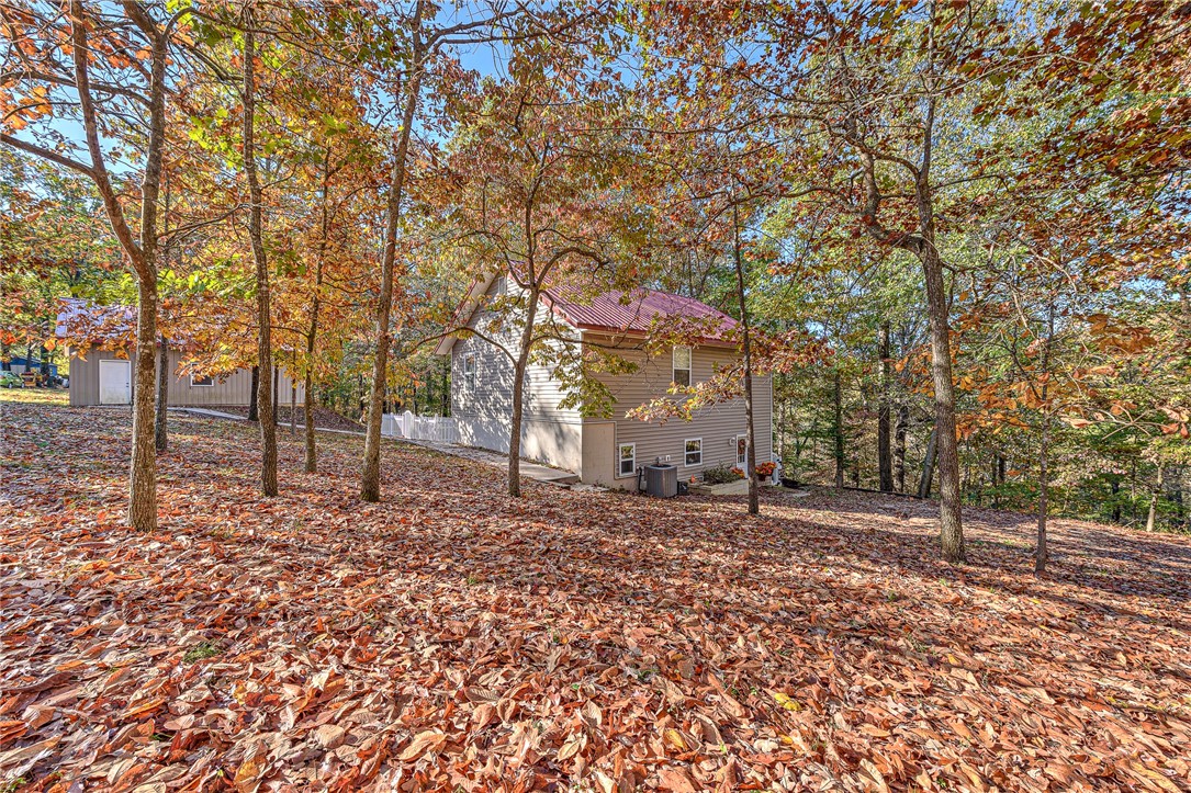 Close to Beaver Lake This home sits on a 3 acre Treed lot and has a 36x30 Detached Garage. This home is built with 6 inch walls and a maintenance free exterior. The master bedroom is oversized and has a large closet and a private deck overlooking the treed acreage. The home has LVP floors downstairs, Tile floors in the bathrooms and carpet in the Bedrooms. There is a woodstove in the living room and a large deck out side to enjoy the outdoor setting. This home is just minutes to downtown Rogers for convenience of shopping and dinning.