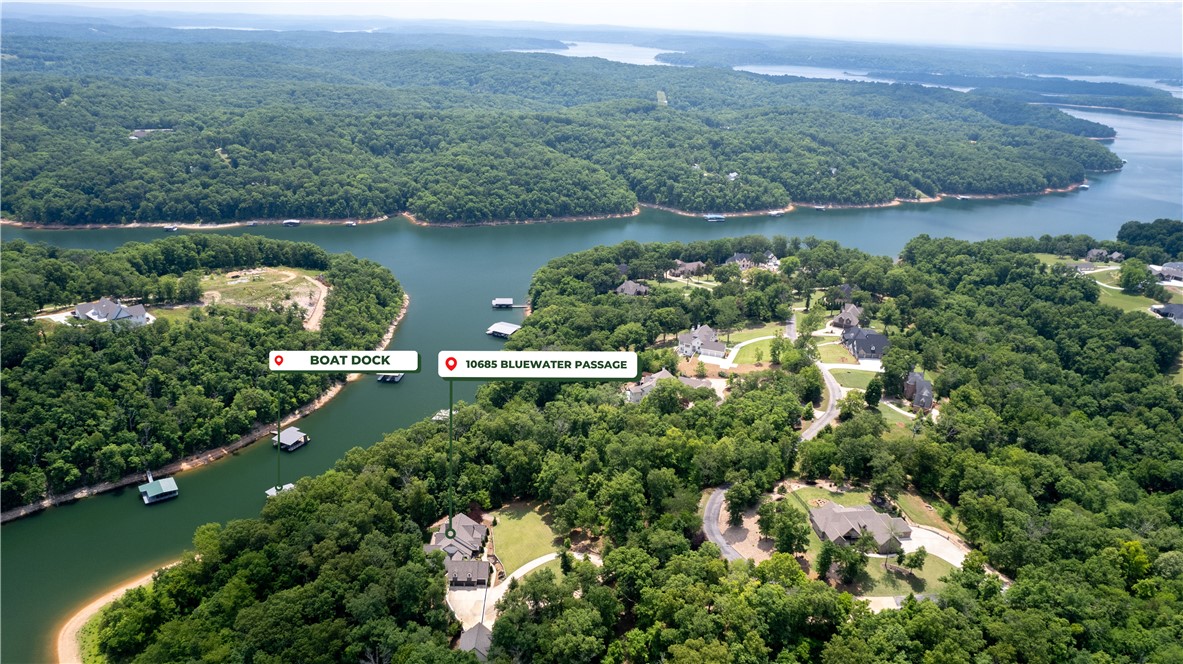 Stunning Lakefront Home w/PRIVATE new 2 Slip Boat/Swim Dock in Gated Community w/over 1,000 ft of Shoreline! 3 Lots totaling 5.27 Acres. Impeccably renovated w/highest attention to quality &detail. Hand scraped wood floors, stained trim & crown molding, plantation shutters, fully wired for sound & new lighting throughout. Office/4th bedroom on main. Living room w/ vaulted & beamed ceilings, stone fireplace, floor to ceiling windows & access to patio. Kitchen w/large island, custom cabinets w/pullout drawer features, gas oven w/pot-filler, built-in fridge, beverage bar & more! Butler’s pantry. Large Laundry room w/sink & storage. Office w/built-ins. Mud rm & add. Storage. Master suite w/access to covered patio w/ fireplace, custom barn door into bath, his/her closets, soaking tub & walk-in shower. Downstairs bonus area w/gas fireplace & wet bar. Custom barn door into music room. Exercise room. Media room w/ snack bar & 110-inch screen & projector. 2 guest beds & baths lower level, Contact agent for list of upgrades