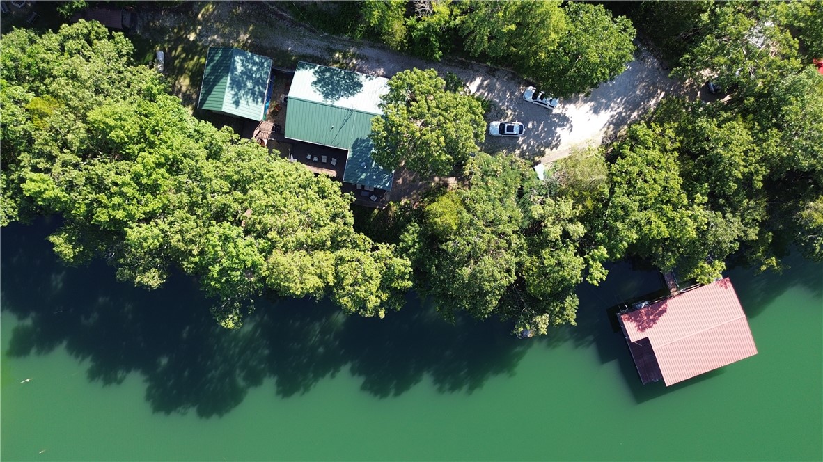 Experience premier lakefront living on over seven acres, complete with a private boat dock and a gentle walk to the sparkling shoreline of Beaver Lake. This extraordinary estate offers more than 3,500 sq. ft. of heated living space designed for comfort, style, and connection.
Do you love to entertain? This property boasts an entire building dedicated to hosting unforgettable gatherings, in addition to the main residence featuring five bedrooms, five bathrooms, generous living areas, a gourmet kitchen, and two expansive lake-view patios—perfect for both lively celebrations and quiet moments.
With uninterrupted shoreline views, direct water access, and exceptional gathering spaces, this property is a rare blend of privacy, natural beauty, and refined living. Fully furnished and move-in ready, it’s prepared for you to start enjoying lake life immediately. Whether envisioned as a full-time residence, luxury retreat, or investment, it offers the very best of the Beaver Lake lifestyle. Call for more details!