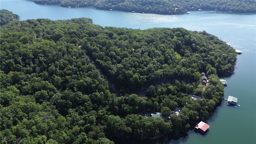 Experience premier lakefront living on over seven acres, complete with a private boat dock and a gentle walk to the sparkling shoreline of Beaver Lake. This extraordinary estate offers more than 3,500 sq. ft. of heated living space designed for comfort, style, and connection.

Do you love to entertain? This property boasts an entire building dedicated to hosting unforgettable gatherings, in addition to the main residence featuring five bedrooms, five bathrooms, generous living areas, a gourmet kitchen, and two expansive lake-view patios—perfect for both lively celebrations and quiet moments.

With uninterrupted shoreline views, direct water access, and exceptional gathering spaces, this property is a rare blend of privacy, natural beauty, and refined living. Fully furnished and move-in ready, it’s prepared for you to start enjoying lake life immediately. Whether envisioned as a full-time residence, luxury retreat, or investment, it offers the very best of the Beaver Lake lifestyle. Call for more details!