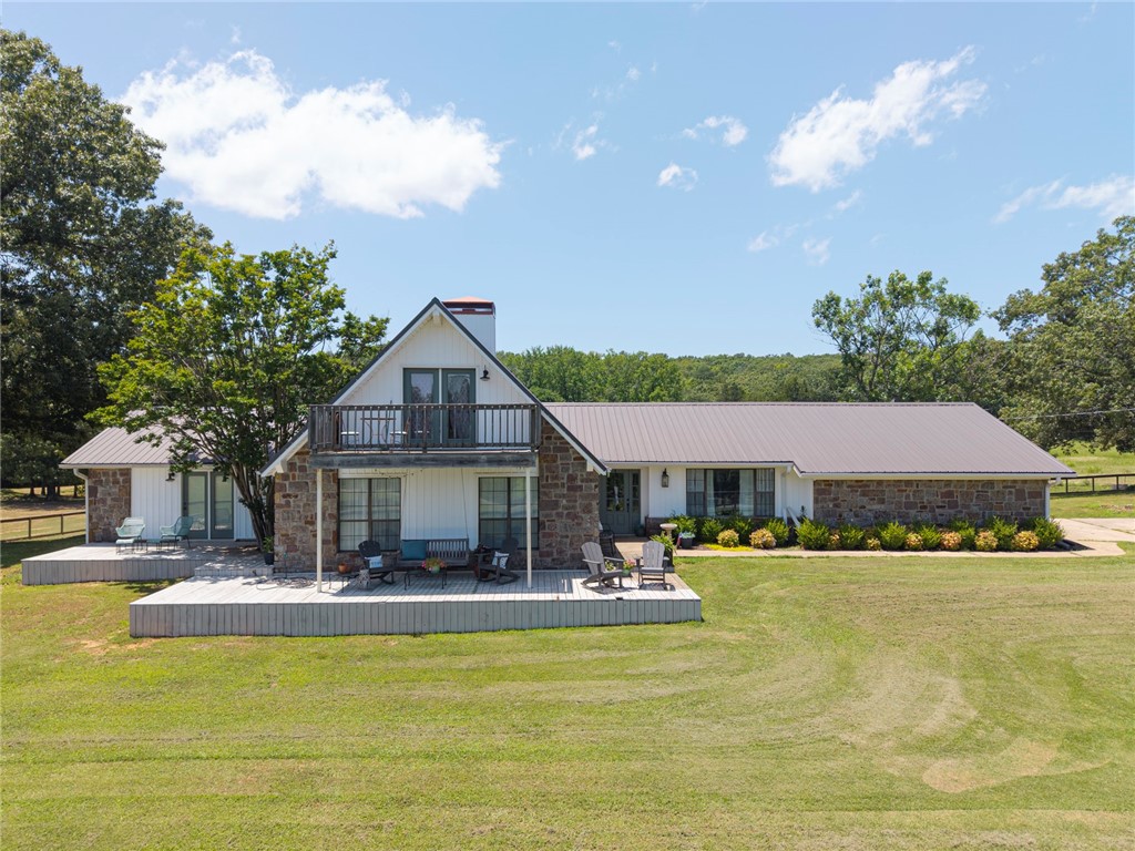 Welcome to your private retreat! This beautifully remodeled home is nestled on 33 picturesque acres and offers the perfect blend of comfort, style, and outdoor living. A newly added heated and cooled sunroom with electric fireplace provides a cozy space to relax or gather with family year-round. Inside, you’ll find wood-look tile flooring, a soaring cathedral ceiling, and a spacious upstairs bonus room with its own private deck. The remodeled kitchen features granite countertops, double oven, ample cabinet space, a breakfast area, and a separate formal dining room—perfect for entertaining. The Jack & Jill bathrooms have been tastefully updated, while the master suite includes a walk-in tile shower, granite countertops, dual vanities, and stylish barn doors. Updates include a 2-year-old metal roof and HVAC system. Step outside to an entertainer’s dream: a covered outdoor kitchen with smoker, grill, fridge, and sink, a sparkling in-ground pool, cross-fenced acreage, a pond, a shop/barn, generator, and WAVE internet.