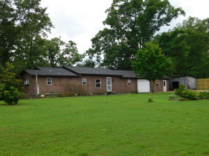 Take a look at this charming, country home. It sits on a bluff overlooking a beautiful valley below. This quiet setting offers plenty of space with a little over 3 acres of land. There is also an established, fenced, raised bed garden spot.