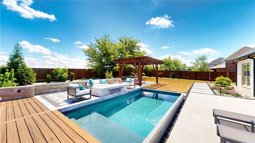 Welcome to your own backyard paradise! This stunning home boasts an incredible outdoor oasis featuring a heated swimming pool, relaxing hot tub, inviting fire pit, and a pergola wired with electric and gas—perfect for entertaining or unwinding. The property offers four spacious bedrooms, including a luxurious master suite, complemented by 3 1/2 beautifully appointed bathrooms. Additionally, enjoy a sizable bonus room on the second level, ideal for a playroom or home office.  Situated on an oversized corner lot, this home includes an expansive three-car garage with new insulated steel garage doors. Beyond the backyard, you'll find direct access to the Greenway trail system, perfect for outdoor enthusiasts.  Conveniently located with easy access to amenities, this property is brimming with upgrades and located within the highly desirable Bentonville school district. Don't miss this opportunity to live in the sought-after Lochmoor subdivision!