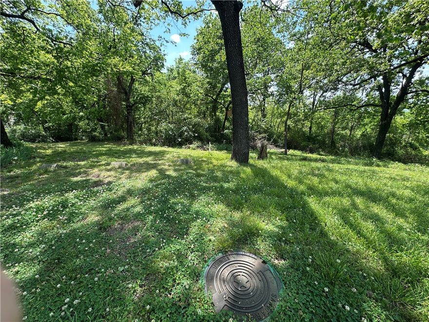Tucked away but still in town, this .24 acre wooded lot in Fort Smith is a rare find for the right buyer.
Sitting at the end of a dead end street, the privacy here is hard to beat. All utilities are at the street,
electric, gas, water, and sewer, so the groundwork is done. The lot is sloped and will need clearing, but
that natural setting is exactly what makes it special. Think tiny home, a peaceful retreat, or a custom
build away from the noise. Small footprint, big potential. At this price, even to purchase for investment
makes sense. Zoned RM-3