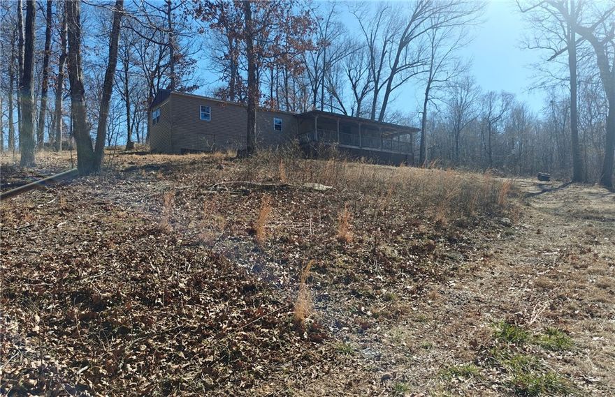 Discover a rare 5.5± acre secluded property just off Hwy 127 — the perfect spot for anyone wanting privacy while staying close to everything. Located at the end of a county road and only about 3 miles from Beaver Lake, this tract offers mature trees, gentle terrain, abundant wildlife, and quick access to Rogers and nearby amenities.

Two mobile homes are on the property and will convey AS-IS. The main unit has had several improvements including a newer roof, vinyl siding, and updated flooring, however the value is placed in the land itself.

Great opportunity for investors, a hobby farm, a build-your-own homestead, or a private weekend getaway.