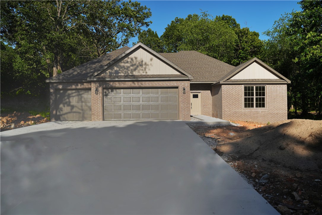 Stunning home with $10,000 buyer credit! Use it to buy down your rate or cover closing costs. Welcome to your new oasis where urban convenience meets country serenity. This captivating single-family home sits on a sprawling 1.01-acre lot, just minutes from the vibrant heart of Bentonville and Centerton.
The home features 4 bedrooms and 2.5 bathrooms, including a spacious master suite and well-appointed baths with high-end finishes. Enjoy an open concept living area with luxury vinyl plank flooring throughout. The expansive 3-car garage offers plenty of room for your vehicles.
Step outside to a beautiful deck overlooking mature trees and tranquil views. Conveniently located near the airport and local events, this home provides the perfect blend of comfort and accessibility. Don’t miss your chance to experience this extraordinary lifestyle!