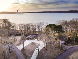 It's more than just a Lake front Home with a boat dock! This beautiful home tells a LOVE story with every beam that was crafted to perfection. You will admire every immaculate detail from the barnwood ceilings, rustic beams, the upgraded wood tile flooring, and 3 luxurious master suites. You're sure to enjoy the gorgeous sunsets overlooking Lake Dardanelle plus hours of Lakefront fun with many memories made. Be the one to complete the Love story of this beautiful Home.