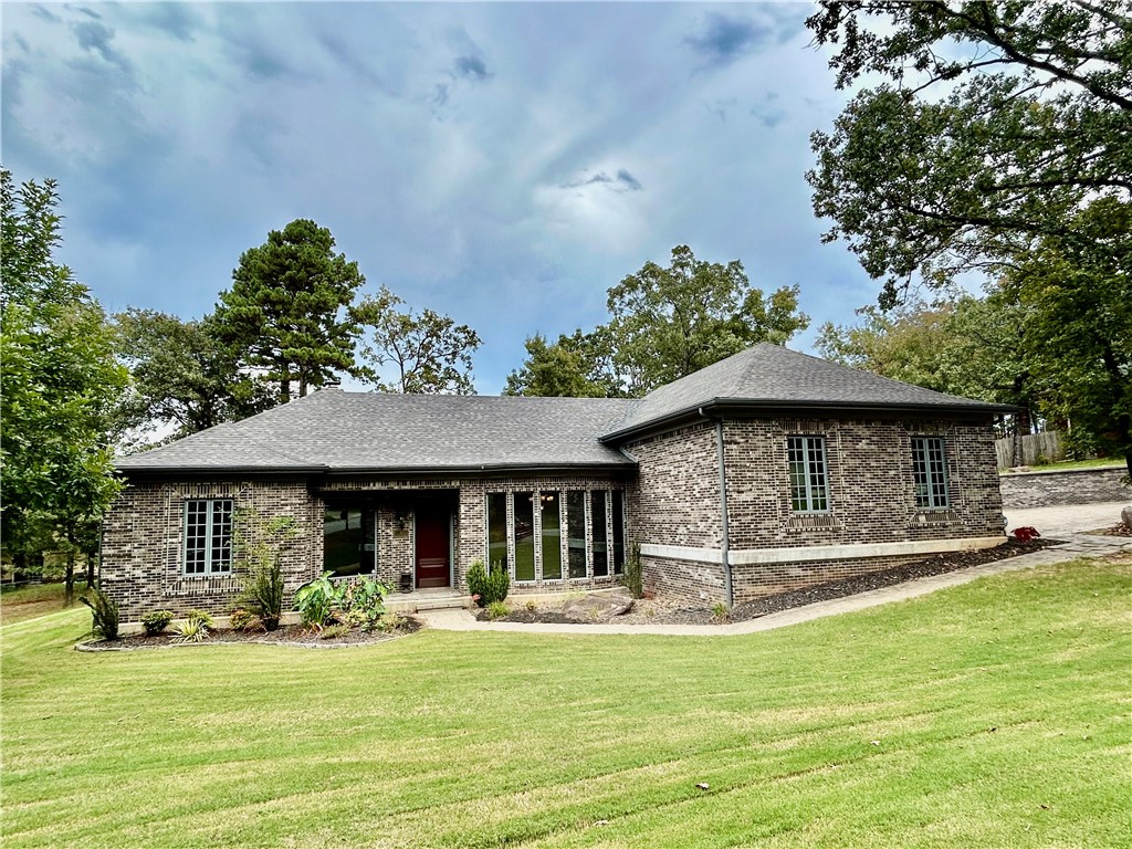 Discover superb craftsmanship in this stunning 3 bedroom, 2 bath home located at 12 Live Oak Ln Russellville. From the moment you enter you'll notice the extraordinary attention to detail, starting with soaring 11-foot ceilings accented by handcrafted wooden beams throughout the main living area. Every cabinet, door, and even the fireplace mantel was custom made by a highly skilled cabinet craftsman, setting this home apart from the rest. Real stone flooring flows throughout most of the home, with cozy carpet in the bedrooms and basement. Modern convenience includes a central vacuum system, security system, and French drains, seamless gutters, and 2.5'thick Belgrade pavers on driveway, back patio, and front walkway provides timeless curb appeal. This one-of-a-kind home blends superior quality with comfort and functionality, offering a rare opportunity to own a property where no detail has been overlooked. This Custom-built, is truly a must see! superior workmanship shows in every detail, perfect for sharing.