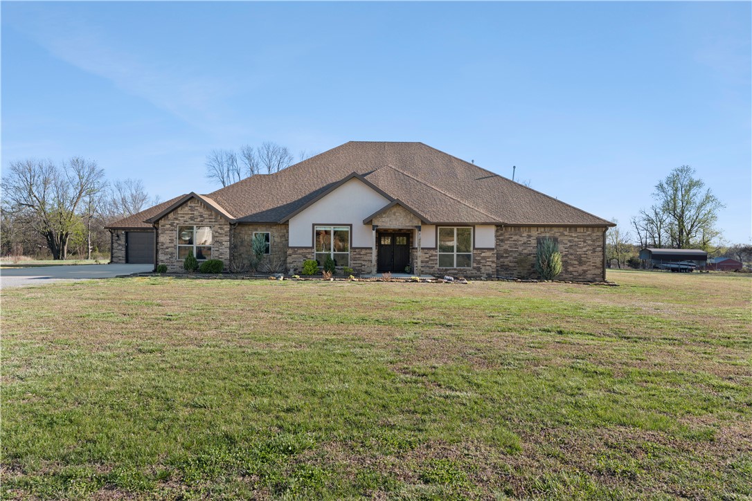 Don’t miss out on this incredible home on 3 acres! Smart home capabilities throughout and every feature is custom-designed and built. 4BR, 3Bath with 2 primary suites and open floor plan. Oversized closets in all rooms have built-in drawers and top-tier finishes. Chef’s kitchen has 6-burner gas stove, double oven, separate upright refrigerator and freezer and 11’ island w/plenty of bar seating. Formal dining room, auxiliary pantry and temp-controlled wine room make entertaining a breeze. Other extras include 2 offices and a walk-in pantry. 2 individual garages hold 4 vehicles and an in-ground storm shelter and are fully finished to match. Outside is a stunning 18x21 in-ground pool, hot tub and pergola surrounded by a brand new concrete patio. Covered porch has ample room for protected outdoor dining and lounging. Beautifully landscaped front yard and fenced back yard. Carport in back of property for additional covered storage.