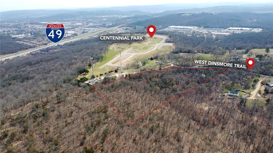 Looking for a beautiful wooded spot to build your dream home but still wanting to be close to everything Fayetteville has to offer? This is it! Enjoy the sunsets from your back patio with an expansive view of the Ozarks. A portion of the property even borders the new Centennial Park! There is a well on the property plus two small ponds that could be kept or filled in. City has approved water as an existing line has already been brought to the property and there has been a perk test completed. This is a great opportunity to own a large, private, parcel of land in the middle of a growing, desirable town. It’s within a few miles of the University of Arkansas and even closer to I-49; yet a paved country road takes you away from the highways up to a quiet location with a view. The perfect spot to build a home with the convenience and accessibility to quickly get wherever you need to be in Northwest Arkansas!