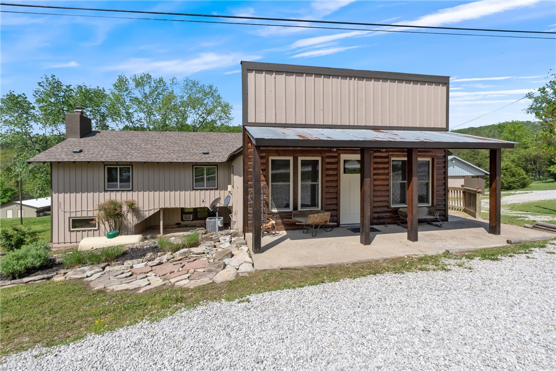 This charming +/- 2,846 SF Airbnb combines comfort with strong income potential. The 5-bed, 3-bath home features hardwood floors, newer windows and roof, 2 fireplaces, full and partial kitchens, and generous storage. Outside, three self-storage buildings offer 32 units—17 rented, 5 for equipment, and 5 for personal use—bringing in $800/month at 55% occupancy, with potential to gross $22K/year with improved management, marketing, and operations. A versatile 30'x100' metal building, once used as a venue/bar, includes a stage, bar top, and large fridge—perfect for events. The Airbnb earns around $370/night in summer, sometimes more if there is an event in town, as there often is in Bustling Eureka Springs! Currently grossing ~$30K/year. Being sold has mostly furnished, with the exception of a few select items, such as the dining table. Just 12 minutes from Eureka Springs off Hwy 62 and 4 min to Beaver Lake Dam Site Park - this property is ideally located for both tourists and locals.