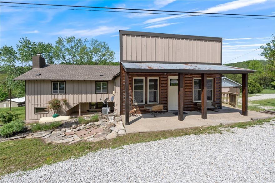 This charming +/- 2,846 SF Airbnb combines comfort with strong income potential. The 5-bed, 3-bath home features hardwood floors, newer windows and roof, 2 fireplaces, full and partial kitchens, and generous storage. Outside, three self-storage buildings offer 32 units—17 rented, 5 for equipment, and 5 for personal use—bringing in $800/month at 55% occupancy, with potential to gross $22K/year with improved management, marketing, and operations. A versatile 30'x100' metal building, once used as a venue/bar, includes a stage, bar top, and large fridge—perfect for events. The Airbnb earns around $370/night in summer, sometimes more if there is an event in town, as there often is in Bustling Eureka Springs! Currently grossing ~$30K/year. Being sold has mostly furnished, with the exception of a few select items, such as the dining table. Just 12 minutes from Eureka Springs off Hwy 62 and 4 min to Beaver Lake Dam Site Park - this property is ideally located for both tourists and locals.