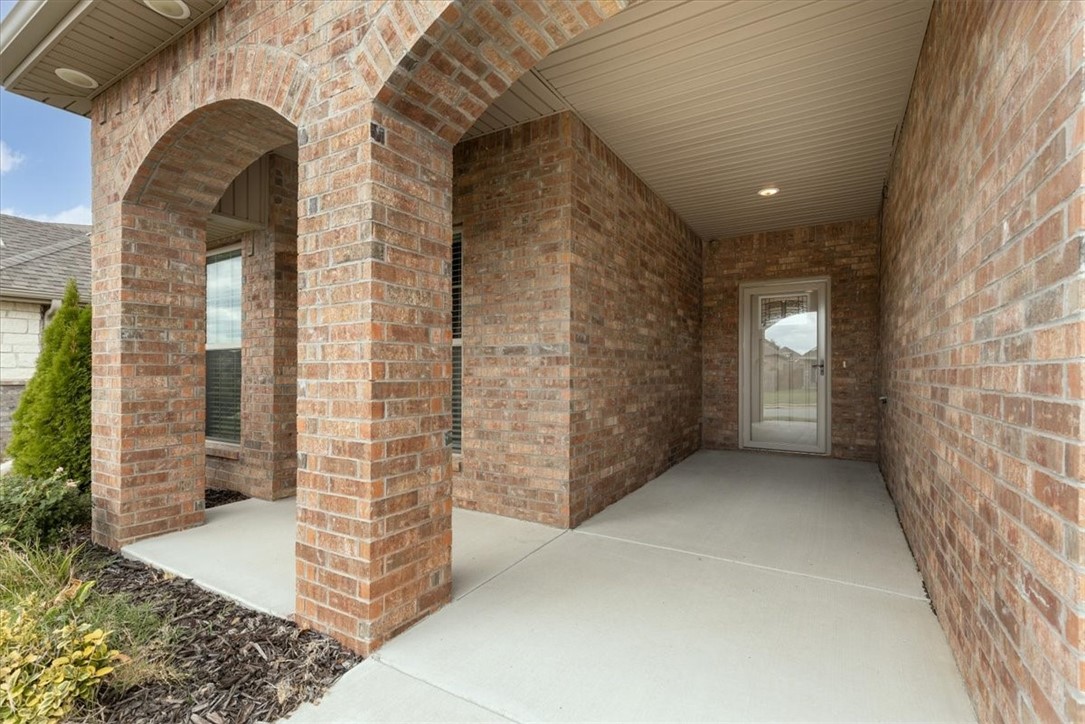 Close to the Walmart Office, Downtown Square, & Bentonville Schools, this unique custom designed home is complete with a secret 3-car tandem garage. Open concept living with a split-floor plan in this sturdy all brick home. Your oversized kitchen has a gas range, beautiful cabinetry, & thick gorgeous granite countertops complete w/ a coveted butcher block island. Your connected living room has real hardwood floors, floor outlet lighting, & a mantle ready for your TV. Pet friendly families will appreciate the electronic doggie door! Your stunning master bath has been remodeled with cultured marble, & a low threshold 2-way glass door. Your extra bedrooms are so spacious! Natural light floods your home, & the Storm Doors provide more light w/no weather. As a bonus, the fridge, washer, dryer, & security system all stay! Relax on your covered back porch w/ large side yard w/ a double gate. Your garage has insulated doors, an added level 2 charging plug for e-vehicles, & the tandem bay: which could be used as a workshop!