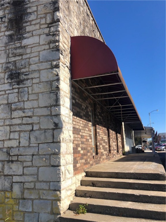 This is a large historic building located on the Berryville Square has office space on Southern side and Retail Space on Northern space lots of storage in garage basement underneath all exterior rocks were quarried locally and timber used cut locally as well approx 1920's age of building.