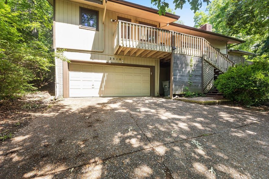 Tucked into a beautifully wooded lot with sweeping winter views over Fayetteville, this elegant 3-bedroom, 2-bath residence offers 2,502 square feet of timeless charm and modern comfort. Rich original hardwood floors, a striking wood-burning fireplace, and soaring ceilings in the living room create a warm yet spacious atmosphere. An additional sleeping area with a kitchenette provides versatility for guests or extended stays, while generous storage off the garage ensures convenience. The home’s natural setting offers privacy and tranquility, all just moments from Fayetteville’s vibrant core. Enjoy close proximity to the scenic Greenway Trail and the city’s premier dining, shopping, and cultural attractions. A rare opportunity to own a serene retreat in one of Northwest Arkansas’s most sought-after locations.