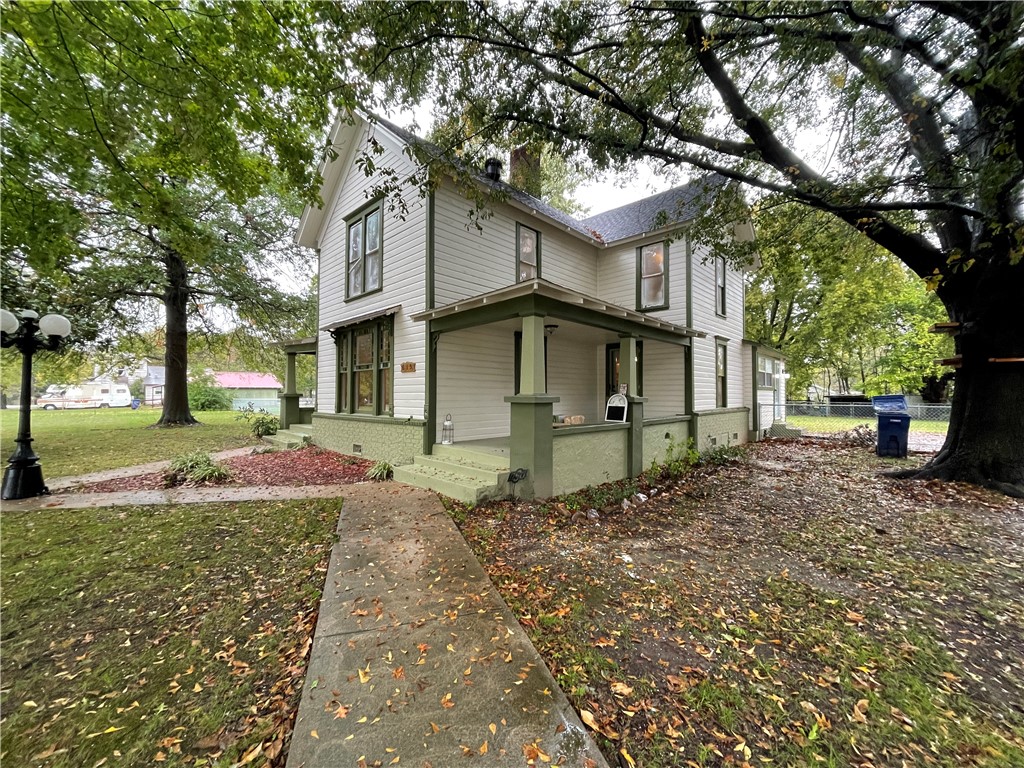 Lovely historical home, just steps from Downtown Siloam Springs. Inside you will find 4 bedrooms, 2 full baths, and a large dining room with tons of storage on a 1.46-acre corner lot. This home has been freshly painted inside and out, new carpet laid in all bedrooms, some new plumbing including all-new from the street to the home, windows resealed, and all hardwood floors refinished. You will love the original hardwood flooring, clawfoot bathtub, beautiful stained glass, and eye-catching trim work throughout. Intricate details on the exterior show true curb appeal. Detached is an oversized 2 car garage with a workspace downstairs and an unfinished bonus room upstairs. Enjoy a quiet summer evening on 1 of your 2 front porches or in your large backyard/patio area. This home is perfect for a family, Air B&B, or a bed and breakfast. The possibilities are endless. Don't miss out on this beautiful one-of-a-kind home! 1/2 mile from downtown Siloam, Memorial Park, and all their local shops and restaurants.