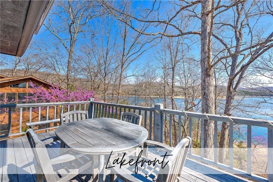 You'll be awed by the views and proximity of the lake with this stunning lakefront home in Lost Bridge Village! Step inside and soak in the breathtaking views of Beaver Lake from the spacious great room with its stunning cathedral windows. The primary suite is upstairs, offering a peaceful escape with its own bathroom with dual vanities. The full kitchen upstairs is equipped with everything you need, making meal prep a breeze and there's even a cozy sunroom to enjoy.  Downstairs is designed to be complete living quarters should you need. Here you'll find another full kitchen and two large bedrooms, each with its own bathroom for added convenience and an extra laundry room. If you need more bedroom space you could convert a large storage area or sunroom space. The home was designed with wheelchair accessibility in mind, making it welcoming for everyone. Also, there is direct access to the lake, perfect for enjoying water activities or simply relaxing by the shore. Don't miss out on this fantastic lakefront retreat!