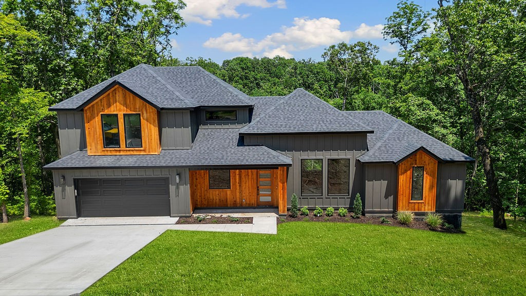 Welcome home to a stunning new construction home nestled in the heart of Bella Vista near the shores of beautiful Lake Loch Lomond. Located just minutes from lake access & scenic trails, this thoughtfully designed traditional-style home has a contemporary flair with black finish & cedar trim. Step inside to an open floor plan with natural light, a spacious living area & a large kitchen featuring ss appliances, satin bronze fixtures & large waterfall island for entertaining. Fall in love with this expanded Mantle and gas fireplace. The main-level primary suite consists of a luxurious ensuite bath & walk-in closet. 2 additional bedrooms are located upstairs along with a large landing—perfect for an office nook. Step out back to a 12x20 (240 sq ft) covered deck overlooking the peaceful, wooded surroundings of your own private escape. Bella Vista is a haven for outdoor enthusiasts with 9 golf courses, scenic lakes, over 100 miles of world-class trails & coming soon~ the state's first mountain biking chairlift.