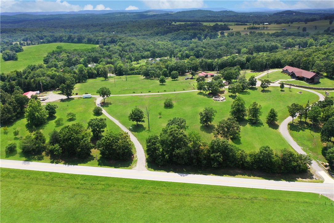 Unbelievable views. Custom built 4 bedroom, 3 bath, single level, 2 car garage with over 3,000 sq ft home. Cathedral ceilings in living room, sunroom and 9 ft ceilings in the remainder of the house. Move in ready mini/hobby farm with readymade garden, 46ā x 25ā barn, loafing sheds, chicken coops, and 1,800 sq. ft. shop with 2 - 12ā x 11ā roll up doors. Over 25 acres, including 18 acres m/l of web wire fencing and cross-fenced with 5 separate pastures and spring fed pond. Guest/party house with over 1,000 sq ft and ācook shedā has over 500 sq ft for entertainment. One-of-a-kind fire pit. Chain link fenced dog run. Apple, peach, pear, cherry and nectarine trees. Large rocks were brought in and strategically erected on 3 sides of the house which accents this property uniqueness. Great location just minutes from town, 2 lakes and 3 rivers. Donāt miss out on this fabulous listing. Also, contains parcel #002-09566-004