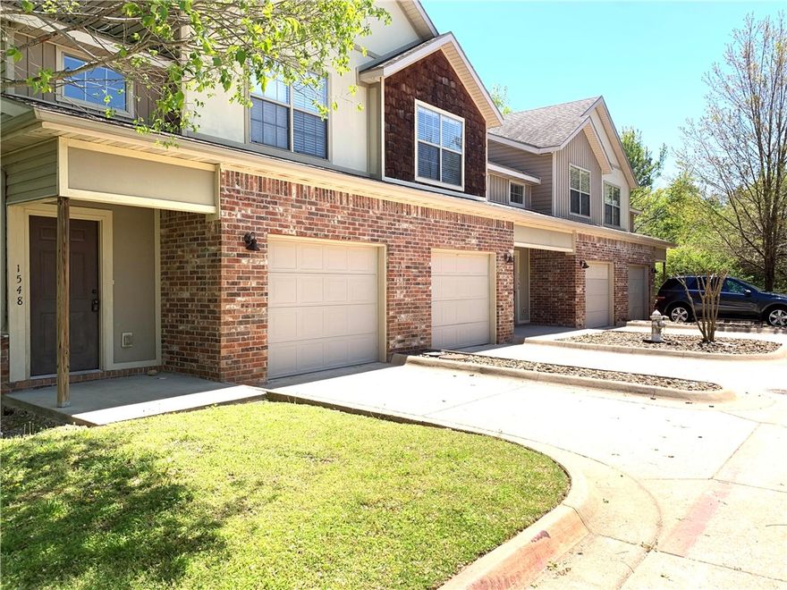 Available April. Fabulous 3 bedroom, 2.5 bath townhouse in a convenient Fayetteville location! Minutes from University of Arkansas, shopping, restaurants and more. Large, open living room with luxury vinyl plank flooring. Awesome kitchen has wood cabinetry with lots of cabinets and drawers, granite countertops and island. Full-size refrigerator, range, dishwasher and microwave. All bedrooms are upstairs and each have ceiling fans and carpet. Large primary bedroom has vaulted ceiling and private bath (shower/tub combo). Full size washer and dryer are conveniently located just outside the bedrooms. Unit includes a one-car garage and parking in unit driveway. Note: Interior pictures are of similar unit in same building. Tenant occupied until 3/31. Application fee $25 per adult. Security Deposit $1,695. Cleaning Fee $415.