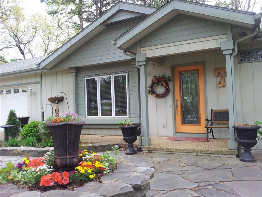 Designer touches throughout! From the welcoming stone patio and exquisite front door, to the delightful sunroom, to the spa-like remodeled bathrooms, this home is filled with design detail. (How about a 16-inch rainfall shower head!) The cozy kitchen is wide open to the Bella Vista views in the sunroom. Back deck is accessible from both the master bedroom and sunroom. In addition to the large driveway there is additional parking alongside the 2 car garage. Honestly, you have to see this one to believe it!