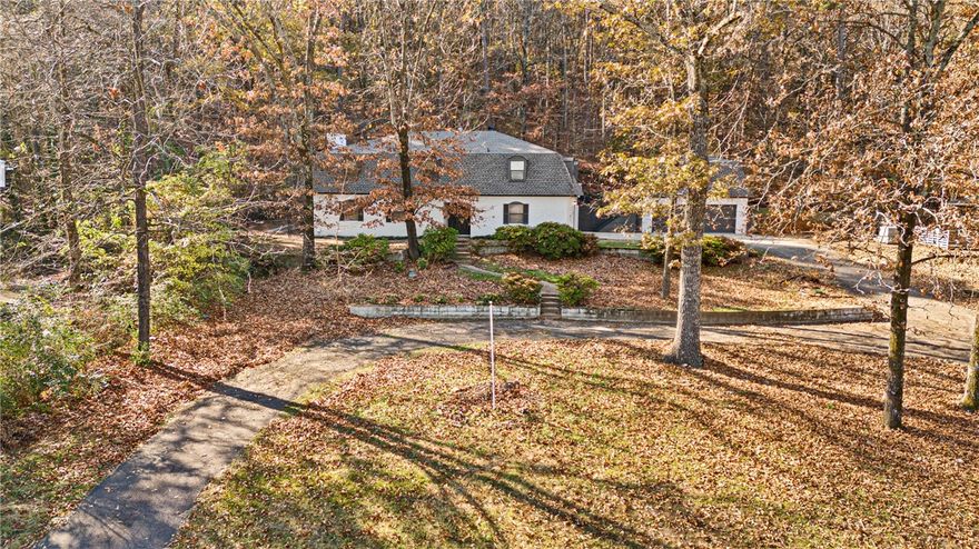 Perched on a hill with a private, in-town setting, this beautifully updated 3,720 sq ft two-story home blends modern comfort with original charm. With 5 spacious bedrooms and 4.5 baths, it features fresh flooring and paint throughout, a new roof, and updated countertops. Thoughtful updates that enhance its timeless character. Inside are two spacious living rooms, a formal dining room, and a dedicated office. Enjoy the two fireplaces, one in the inviting living room and another in the serene primary suite. Set on a full acre, this property offers room to relax and breathe while remaining close to everything. Move-in ready and full of warmth, it’s the perfect balance of convenience and quiet.